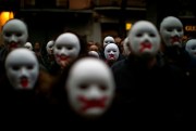 People wear white masks in support of Catalonian politicians jailed on charges of sedition during a protest in Figures, Spain, April 5, 2018 (AP photo by Emilio Morenatti).