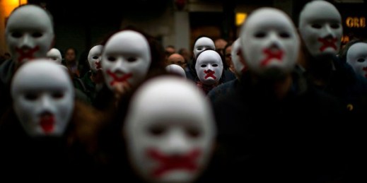 People wear white masks in support of Catalonian politicians jailed on charges of sedition during a protest in Figures, Spain, April 5, 2018 (AP photo by Emilio Morenatti).
