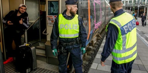 Swedish police prepare to check an incoming train at the Swedish end of the bridge between Sweden and Denmark, Malmo, Sweden, Nov. 12, 2015 (TT photo by Stig Ake Jonsson via AP).
