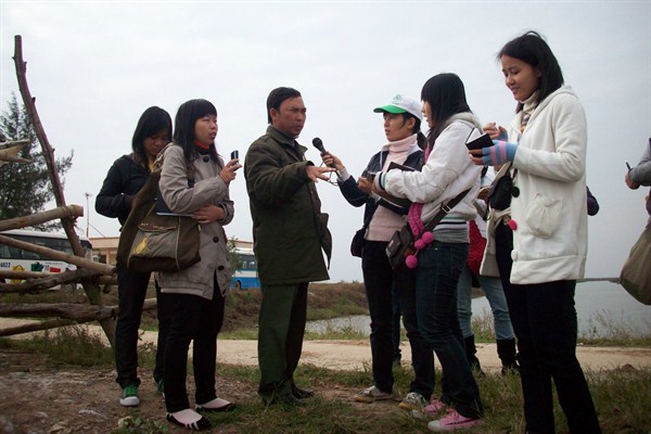 Citizen science volunteers interview a forest ranger about environmental threats to Xuan Thuy National Park, Vietnam, Undated (Photo courtesy of Do Hai Linh/Pan Nature).