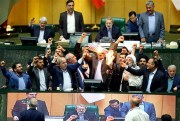 Iranian lawmakers burn pieces of paper representing the American flag and the nuclear deal as they chant slogans against the U.S., Tehran, Iran, May 9, 2018 (AP photo).