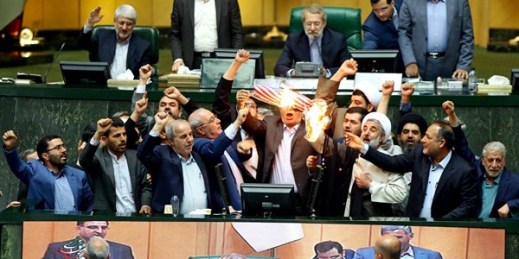 Iranian lawmakers burn pieces of paper representing the American flag and the nuclear deal as they chant slogans against the U.S., Tehran, Iran, May 9, 2018 (AP photo).