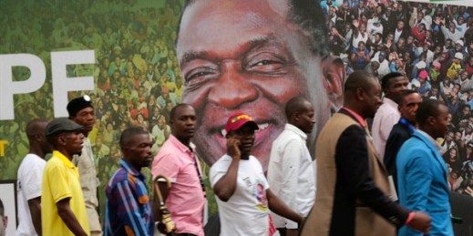 Pedestrians walk past a campaign poster showing Zimbabwean President Emmerson Mnangagwa during the ruling party’s launch of its election manifesto, Harare, May 4, 2018 (AP photo by Tsvangirayi Mukwazhi).