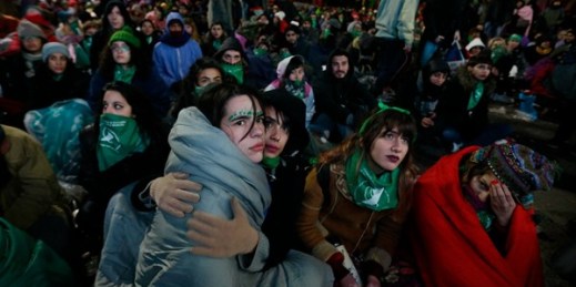Women watch on a big screen lawmakers vote on a bill that would legalize abortion, Buenos Aires, Argentina, June 14, 2018 (AP photo by Jorge Saenz).