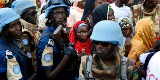 U.N. peacekeepers stand near people queuing to enter a mosque during the visit of Pope Francis, Bangui, Central African Republic, Nov. 30, 2015 (AP photo by Jerome Delay).