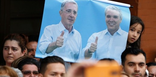 A poster of Colombia’s former president, Alvaro Uribe, and the new president-elect, Ivan Duque, during a campaign rally, Armenia, Colombia, June 10, 2018 (AP photo by Fernando Vergara).