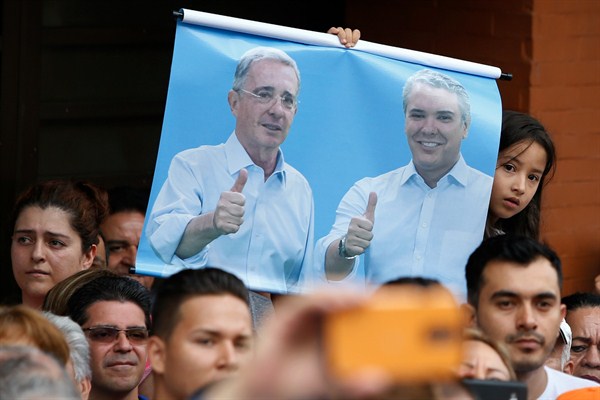A poster of Colombia’s former president, Alvaro Uribe, and the new president-elect, Ivan Duque, during a campaign rally, Armenia, Colombia, June 10, 2018 (AP photo by Fernando Vergara).