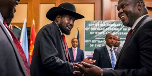 South Sudan’s president, Salva Kiir, and opposition leader Riek Machar, right, shake hands during peace talks at a hotel in Addis Ababa, Ethiopia, June 21, 2018 (AP photo).