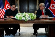U.S. President Donald Trump and North Korean leader Kim Jong Un at a signing ceremony during their meeting on Sentosa Island, Singapore, June 12, 2018 (AP photo by Evan Vucci).