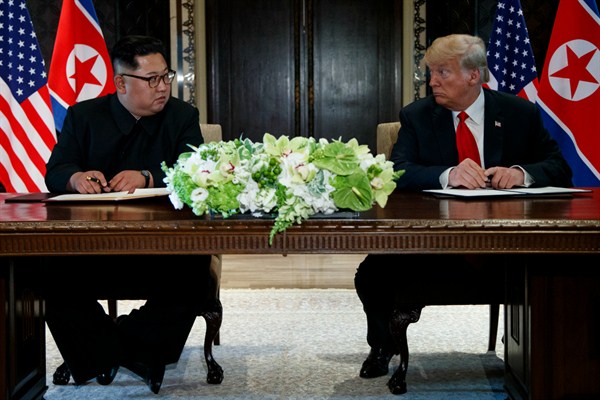 U.S. President Donald Trump and North Korean leader Kim Jong Un at a signing ceremony during their meeting on Sentosa Island, Singapore, June 12, 2018 (AP photo by Evan Vucci).