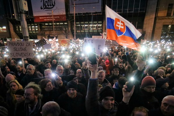 Demonstrators light the torches of their smartphones during an anti-government rally, Bratislava, Slovakia, April 15, 2018 (AP photo by Ronald Zak).