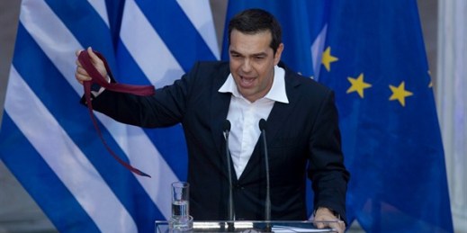 Greek Prime Minister Alexis Tsipras holds a tie at the end of a speech to lawmakers from his left-led governing coalition, Athens, Greece, June 22, 2018 (AP photo by Petros Giannakouris).
