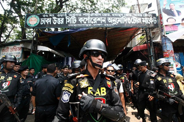 Soldiers from Bangladesh’s Rapid Action Battalion stand guard during a raid on suspected drug dealers, Dhaka, Bangladesh, May 26, 2018 (AP photo by Mehedi Hasan).