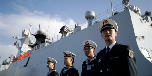 Chinese naval officials stand in front of the ship Daqing, San Diego, Calif., Dec. 7, 2016 (AP photo by Gregory Bull).