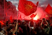 Opponents of the recent name deal between Greece and Macedonia light flares outside the parliament building, Skopje, Macedonia, June 23, 2018 (AP photo by Boris Grdanoski).