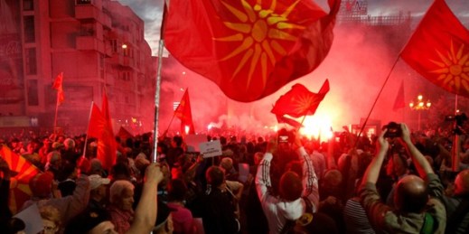 Opponents of the recent name deal between Greece and Macedonia light flares outside the parliament building, Skopje, Macedonia, June 23, 2018 (AP photo by Boris Grdanoski).