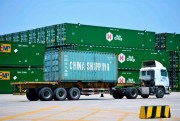 A truck moves a container from China Shipping at a port in Qingdao in eastern China’s Shandong province, July 6, 2018 (ChinaTopix photo via AP Images).