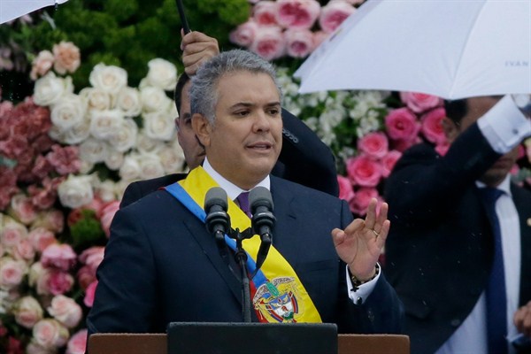 Wearing the presidential sash, Colombian President Ivan Duque speaks during his inauguration ceremony, Bogota, Aug. 7, 2018 (AP photo by Fernando Vergara).