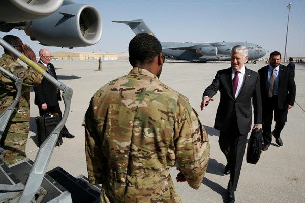 U.S. Defense Secretary James Mattis greets an airman as he boards a U.S. Air Force C-17 Globemaster for a trip to the U.S. military base in Djibouti from Doha, Qatar, April 23, 2017 (Pool photo by Jonathan Ernst via AP).