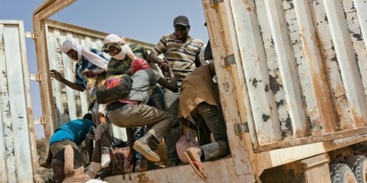 Migrants climb into a truck to head north into Algeria at the Assamaka border post in northern Niger, June 3, 2018 (AP photo by Jerome Delay).