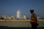 A Chinese construction worker stands on land that was reclaimed from the Indian Ocean for the Port City Colombo project,  Colombo, Sri Lanka, Jan. 2, 2018 (AP photo by Eranga Jayawardena).