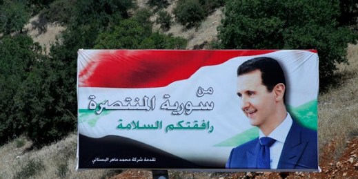 A poster of Syrian President Bashar al-Assad with Arabic that reads “Welcome to victorious Syria,” is displayed on the border between Lebanon and Syria, July 20, 2018 (AP photo by Hassan Ammar).