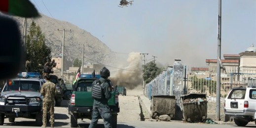 An MD 530F military helicopter targets a house where attackers were hiding, Kabul, Afghanistan, Aug. 21, 2018 (AP photo by Rahmat Gul).