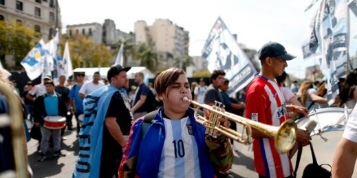 A young demonstrator plays a trumpet during a protest against austerity measures put in place by the government of President Mauricio Macri, Buenos Aires, Sept. 24, 2018 (AP photo by Natacha Pisarenko).
