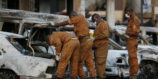 Soldiers examine burnt-out cars outside the Splendid Hotel in Ouagadougou, Burkina Faso, after it was attacked by al-Qaida-linked extremists, Jan. 17, 2016 (AP photo by Sunday Alamba).