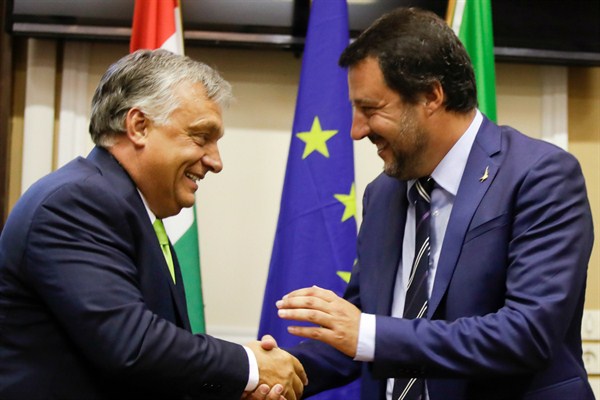 Italian Interior Minister Matteo Salvini, right, shakes hands with Hungarian Prime Minister Viktor Orban after their meeting in Milan, Italy, on Aug. 28, 2018 (AP photo by Luca Bruno).