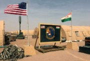 A U.S. and Niger flag are raised side by side at the base camp for air forces and other personnel supporting the construction of Niger Air Base 201 in Agadez, Niger, April 16, 2018 (AP photo by Carley Petesch).
