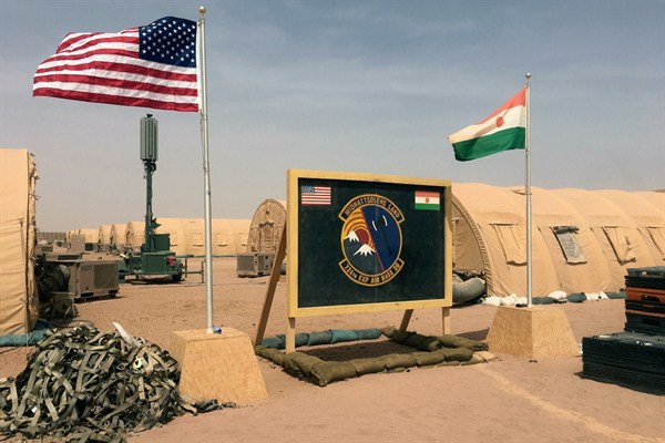 A U.S. and Niger flag are raised side by side at the base camp for air forces and other personnel supporting the construction of Niger Air Base 201 in Agadez, Niger, April 16, 2018 (AP photo by Carley Petesch).