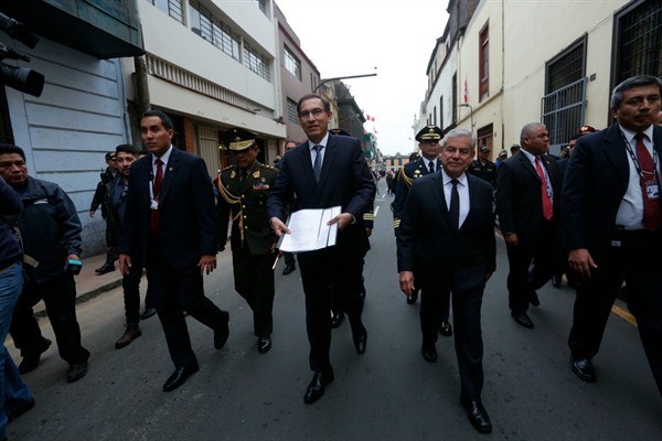 Peruvian President Martin Vizcarra walks to the Legislative Palace, the seat of Peru’s Congress, in Lima, to hand-deliver proposed legislation on political reform, on Aug. 9, 2018 (Photo by Anthony Nino De Guzman for GDA via AP Images).