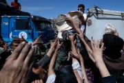 Syrian authorities distribute bread, vegetables and pasta near the site of a suspected chemical weapons attack, Douma, Syria, April 16, 2018 (AP photo by Hassan Ammar).