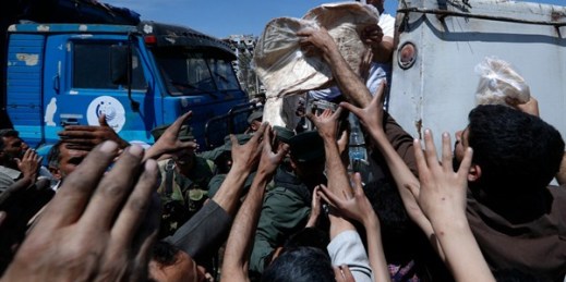 Syrian authorities distribute bread, vegetables and pasta near the site of a suspected chemical weapons attack, Douma, Syria, April 16, 2018 (AP photo by Hassan Ammar).