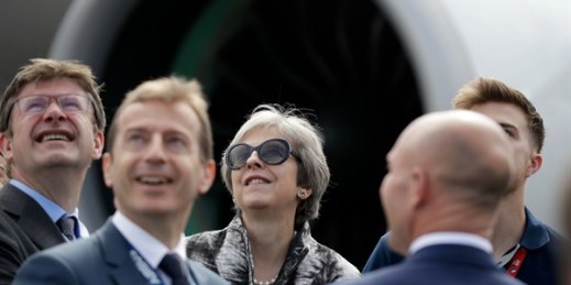British Prime Minister Theresa May looks up as an aircraft flies past during a visit to the Airbus area at the Farnborough Airshow, Farnborough, England, July 16, 2018 (AP photo by Matt Dunham).