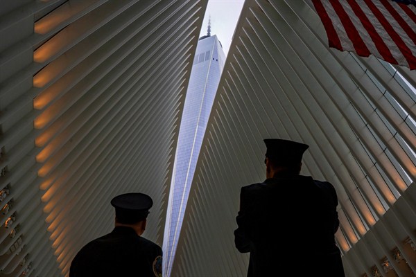 Two New York City firefighters look toward One World Trade Center through the open ceiling of the Oculus at the World Trade Center Transportation Hub, New York, Sept. 11, 2018 (AP photo by Craig Ruttle).