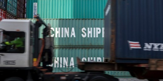 A jockey truck passes a stack of 40-foot China Shipping containers at the Port of Savannah in Savannah, Georgia, July, 5, 2018 (AP photo by 	Stephen B. Morton).