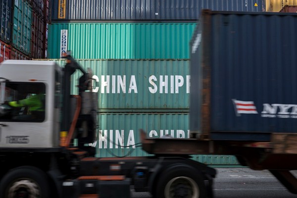 A jockey truck passes a stack of 40-foot China Shipping containers at the Port of Savannah in Savannah, Georgia, July, 5, 2018 (AP photo by 	Stephen B. Morton).