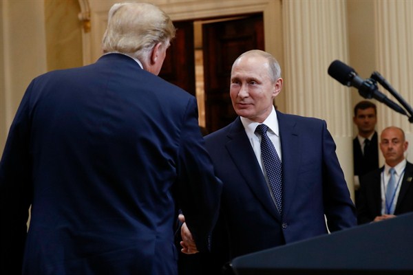 U.S. President Donald Trump, left, and Russian President Vladimir Putin, right, shake hands at the conclusion of their joint news conference at the Presidential Palace in Helsinki, Finland, July 16, 2018 (AP photo by Pablo Martinez Monsivais).