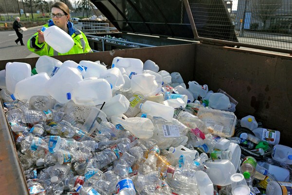 Skagit County Solid Waste Division manager Margo Gillaspy displays some of the recyclable plastic items that had been deposited at the Skagit County Transfer Station in Mt. Vernon, Washington, June 20, 2018 (AP photo by Scott Terrell).