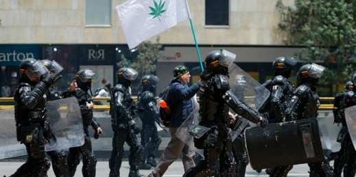 A protester carries carries a flag featuring a cannabis leaf during a student march in Bogota, Colombia, Sept. 6, 2018 (AP photo by Fernando Vergara).