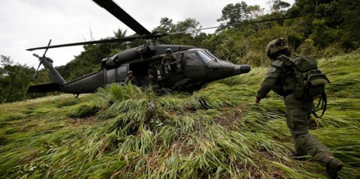 An anti-narcotics police officer runs toward a helicopter after the destruction of a cocaine lab in Calamar, Guaviare state, Colombia, Aug. 2, 2016 (AP photo by Fernando Vergara).