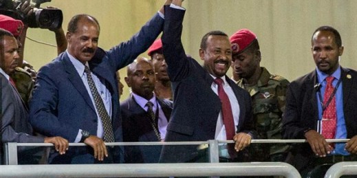 Eritrean President Isaias Afwerki, second left, and Ethiopia’s Prime Minister Abiy Ahmed, center, wave at the crowds in Addis Ababa, Ethiopia, July 15, 2018 (AP photo by Mulugeta Ayene).