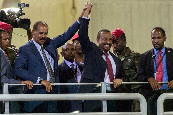 Eritrean President Isaias Afwerki, second left, and Ethiopia’s Prime Minister Abiy Ahmed, center, wave at the crowds in Addis Ababa, Ethiopia, July 15, 2018 (AP photo by Mulugeta Ayene).