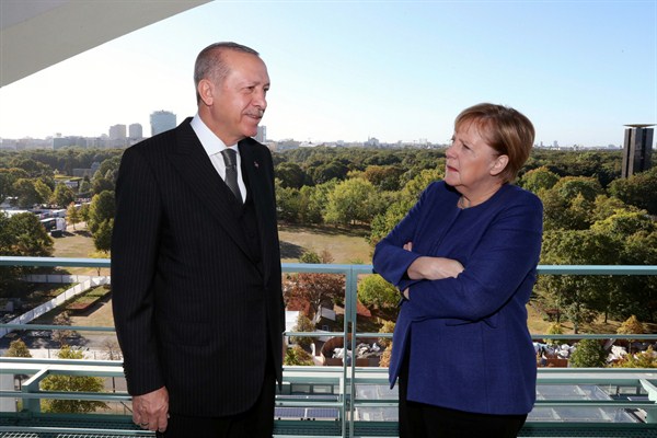 German Chancellor Angela Merkel, right, listens to Turkish President Recep Tayyip Erdogan, left, prior to their breakfast meeting at the chancellery in Berlin, Germany, Sept. 29, 2018 (Presidency Press Service photo via AP Images).