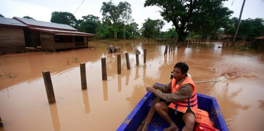 A man paddles his boat through a flooded village in the Sanamxay district, Attapeu province, Laos, July 26, 2018 (AP photo by Hau Dinh).