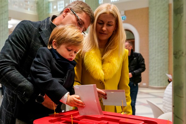 Nils Ushakovs, leader of the pro-Russian Harmony party, with his wife and son, cast their ballots at a polling station during Latvia’s parliamentary elections, Riga, Latvia, Oct. 6, 2018 (Photo by Sergey Melkonov for Sputnik via AP Images).
