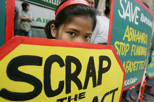 A young protester holds a placard during an anti-mining rally in the financial district of Makati, south of Manila, Philippines, April 23, 2007 (AP photo by Aaron Favila).