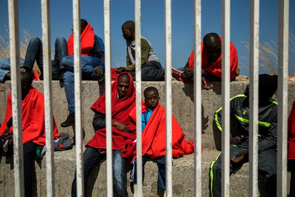 Migrants wait to be transported to a police station after being rescued in the Strait of Gibraltar, Algeciras, Spain, June 26, 2018 (AP photo by Emilio Morenatti).